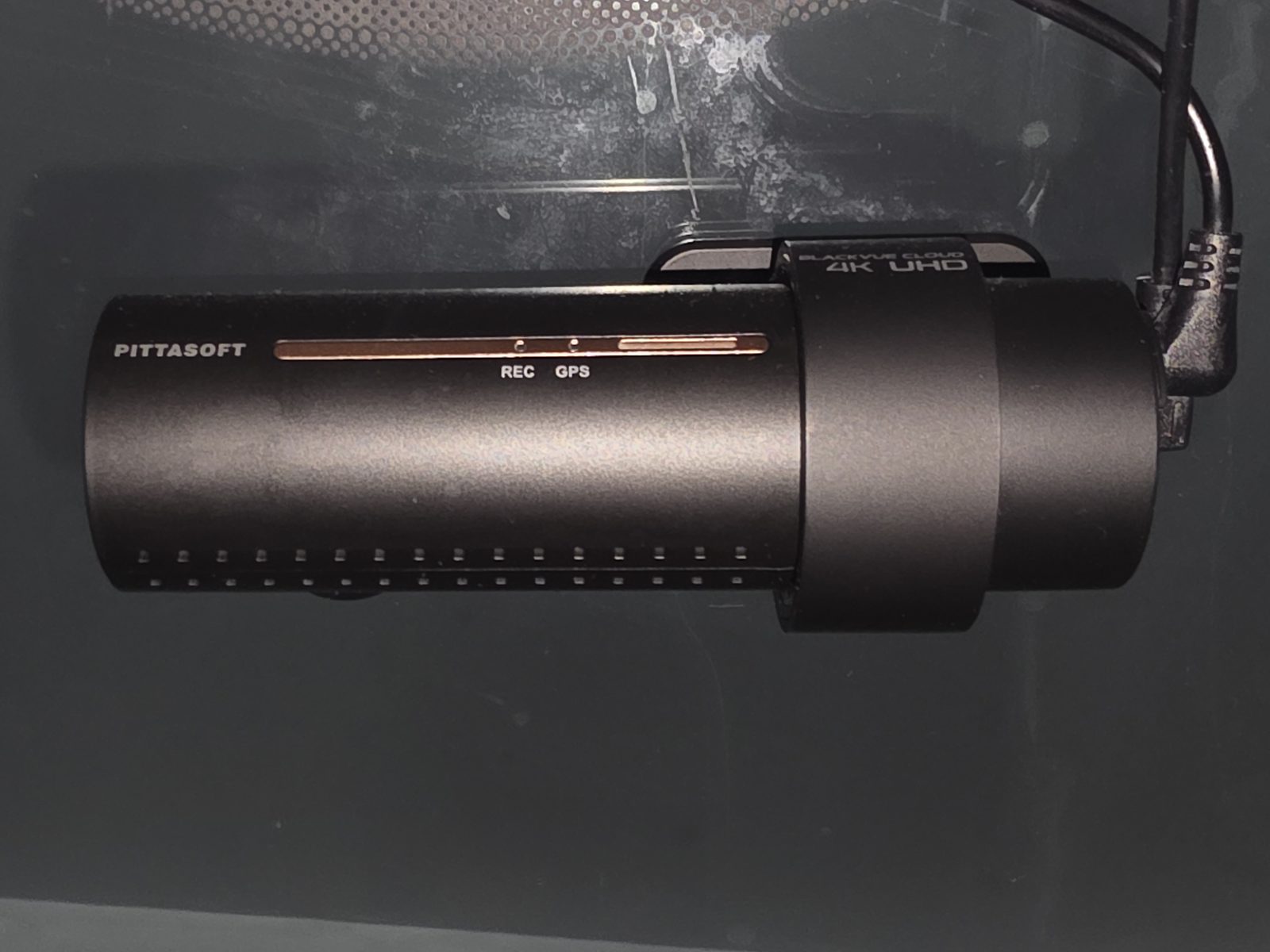 The BlackVue DR900S mounted on the windshield, REC and GPS lit — the camera that finally did live remote viewing.
